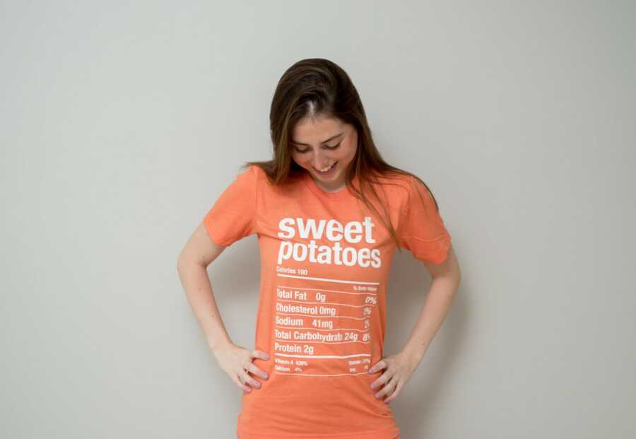 woman showing off her sweet potatoes shirt