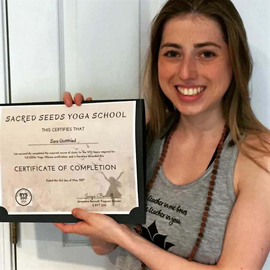 woman receiving yoga instructor certification