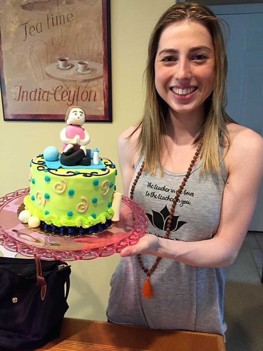 woman with a cake showing her as a yoga instructor