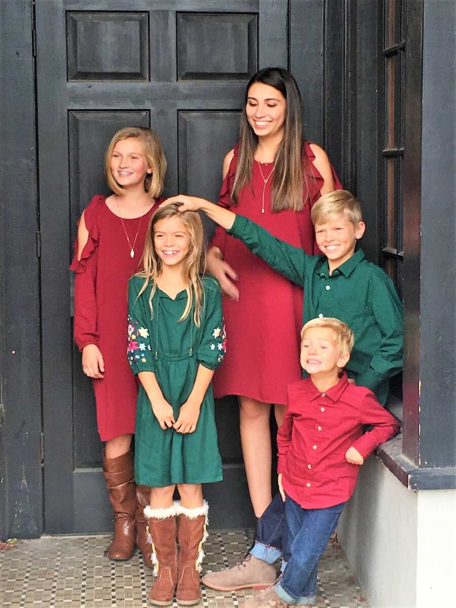 siblings taking christmas photo