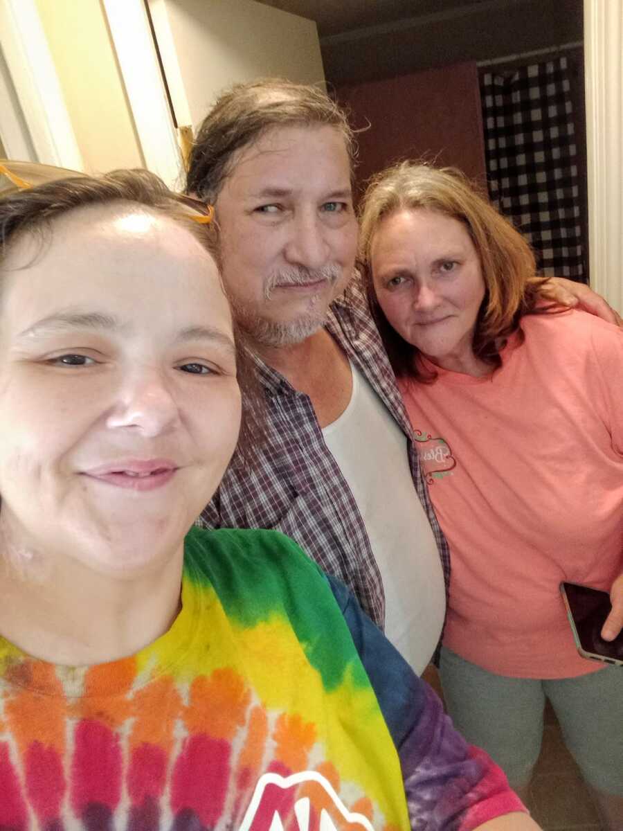 recovering drug addict smiling with her father and his girlfriend