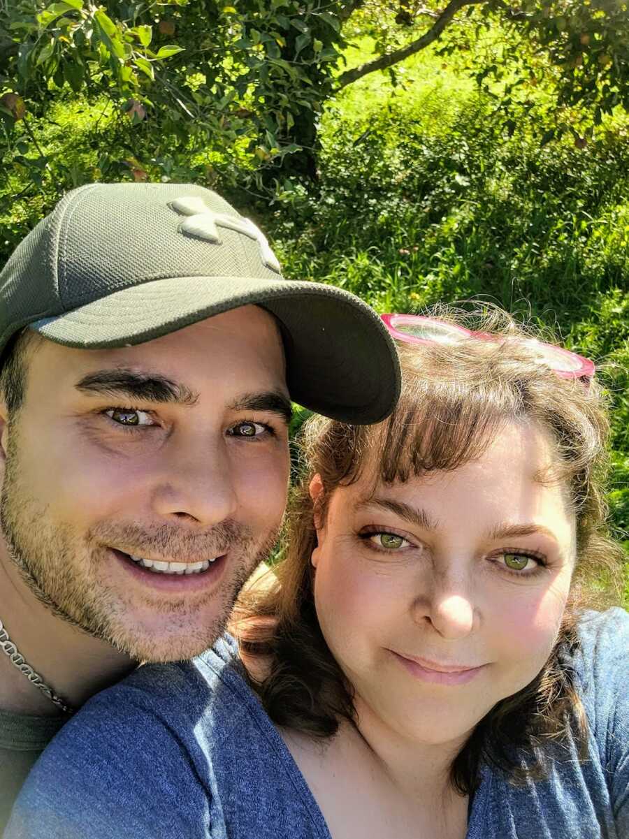 Husband and wife smiling together outdoors