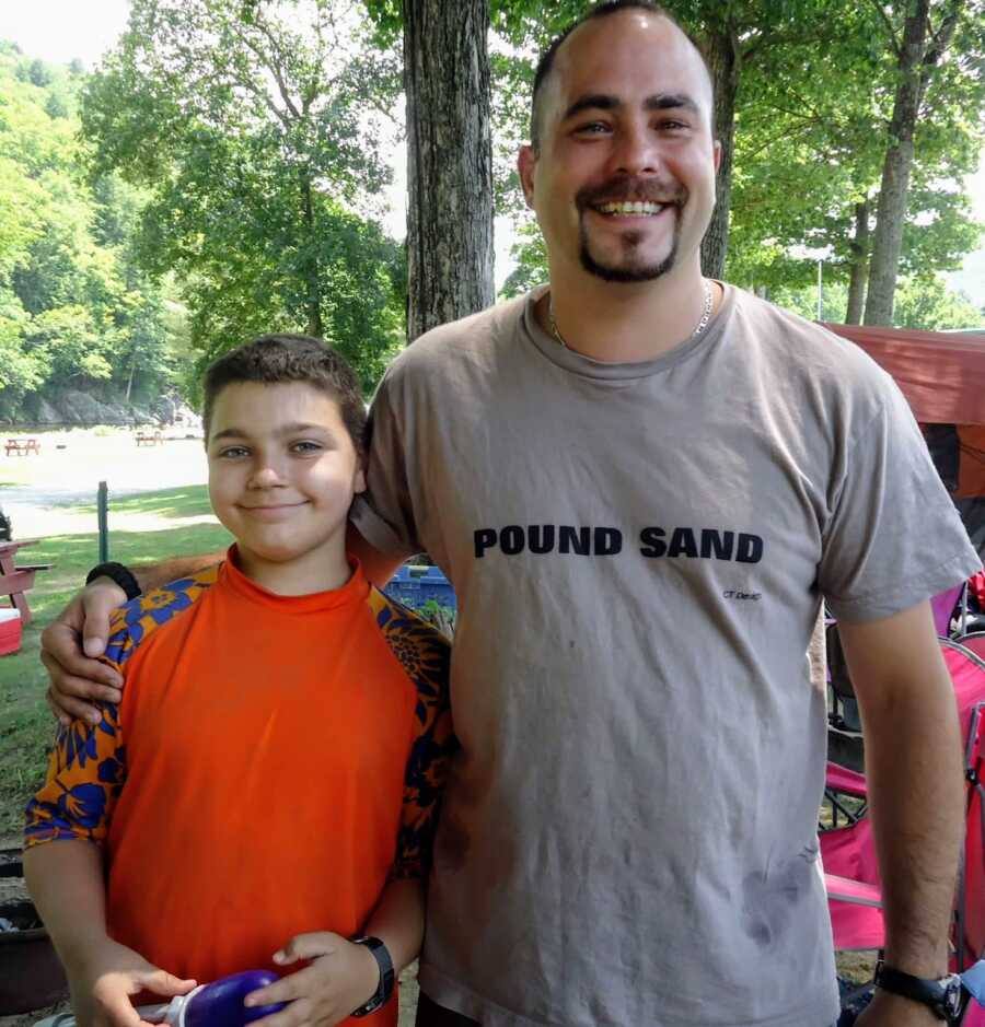 Son and stepdad smiling together