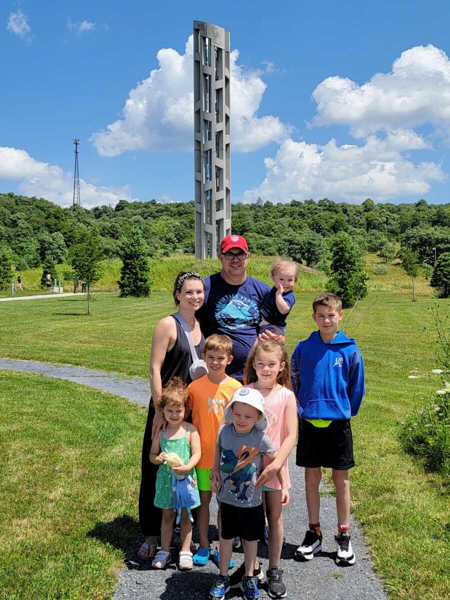 family of eight outside memorial site