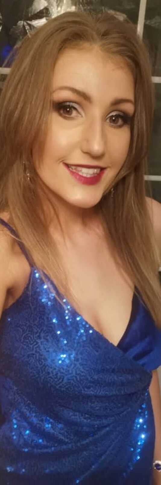 woman with makeup on in blue dress