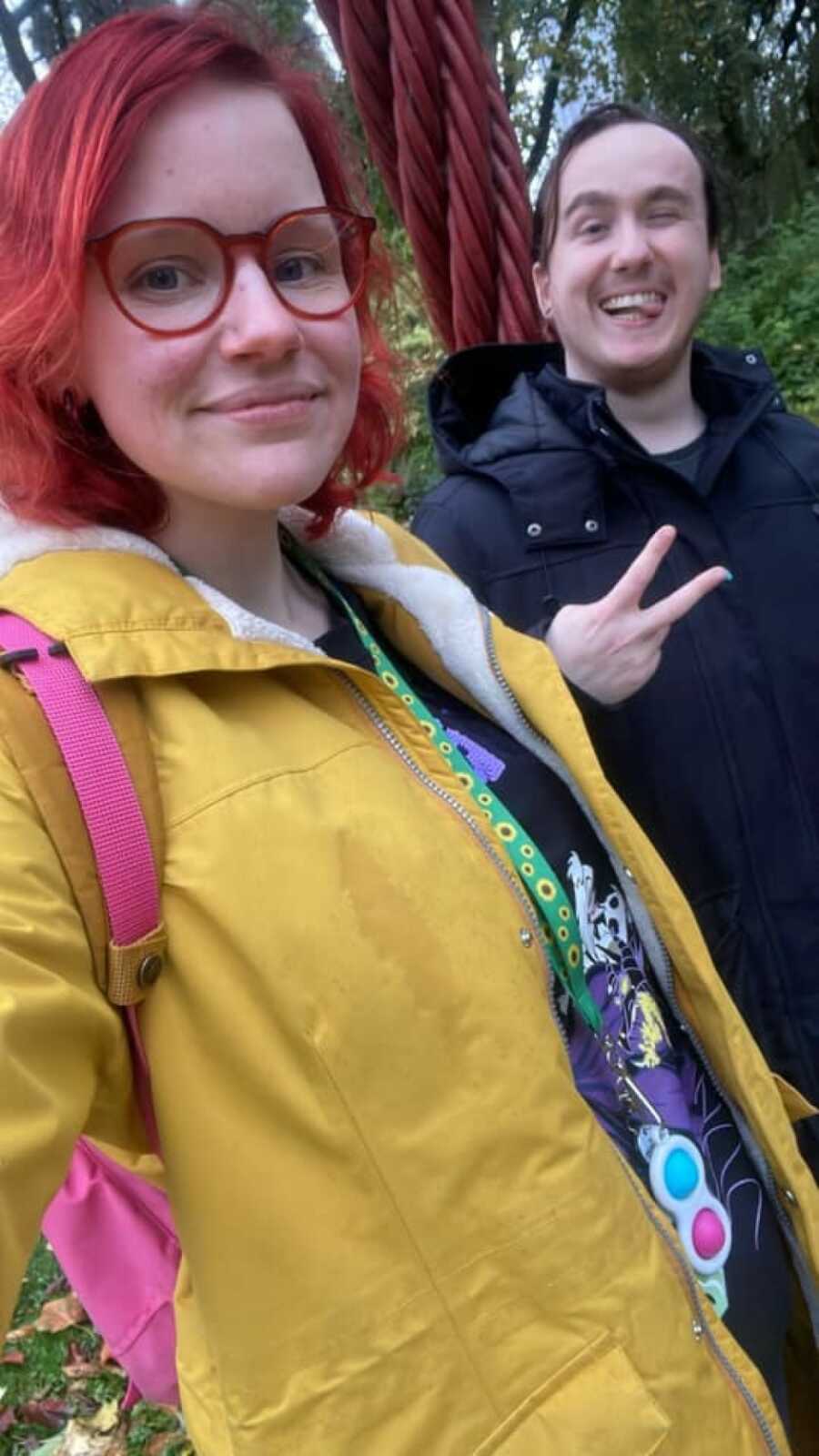 autistic woman in yellow jacket taking selfie with friend