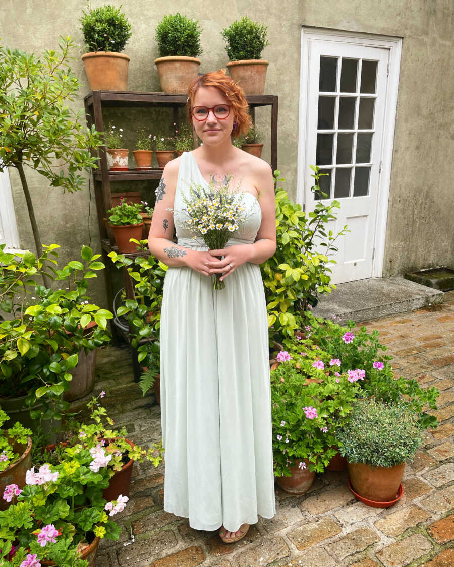 autistic woman standing in white wedding dress