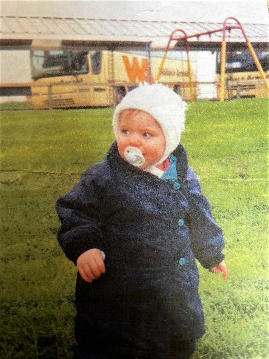 little girl with autism in blue coat