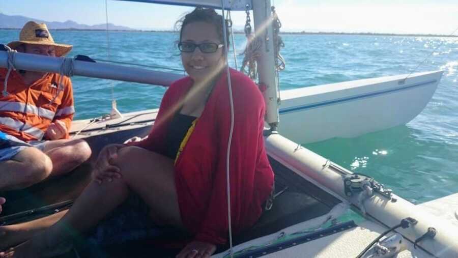 Aboriginal woman sitting on a boat