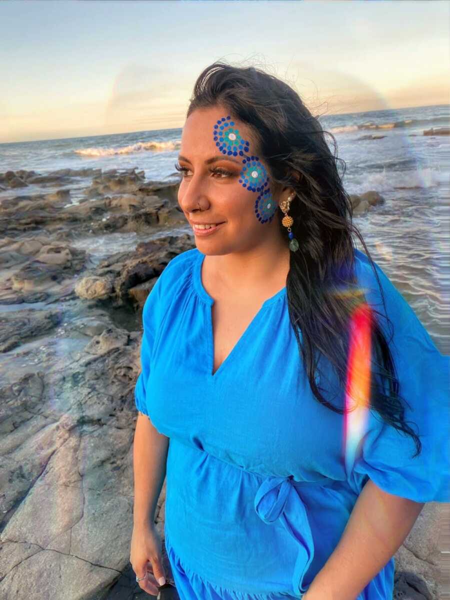 Aboriginal woman at beach with aboriginal face paint