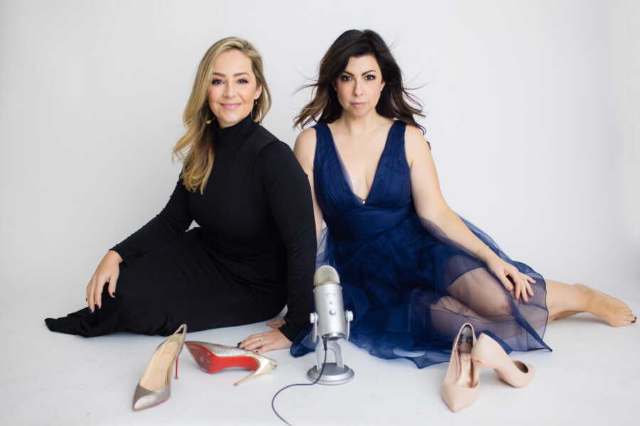 The hosts of How to Not Suck At Divorce pose with their microphone