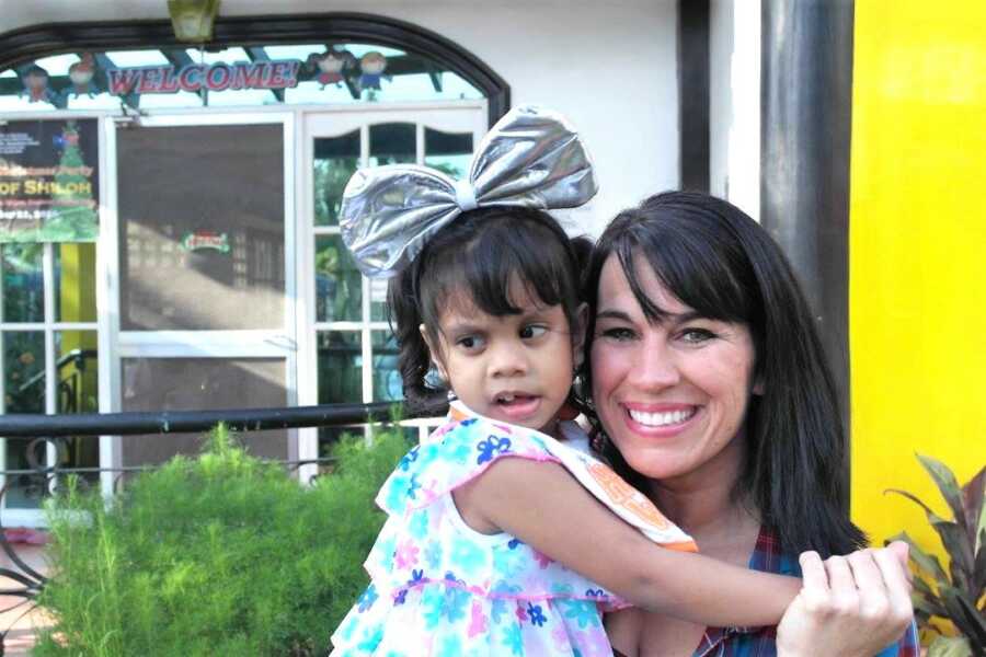 adoption day of young girl, mom holds her daughter