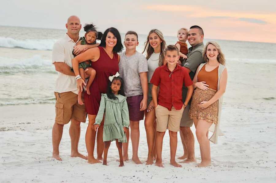 family gathers together while on the beach