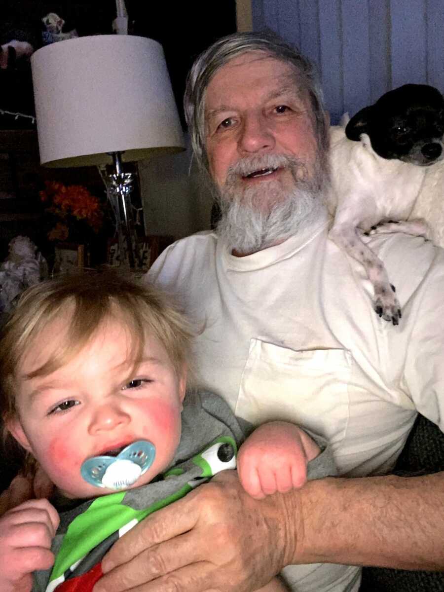 grandson with his grandfather and a dog
