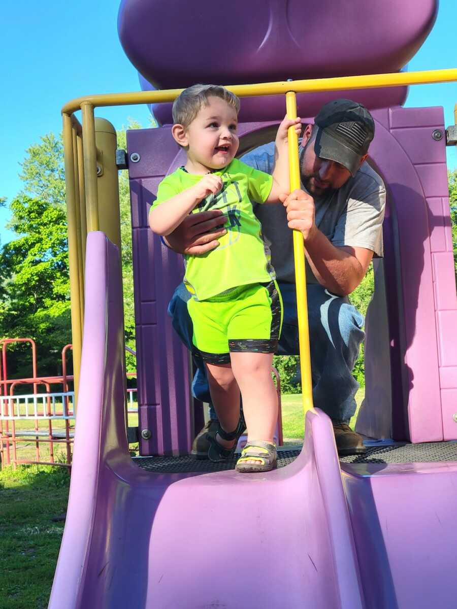 young boy plays on the playground