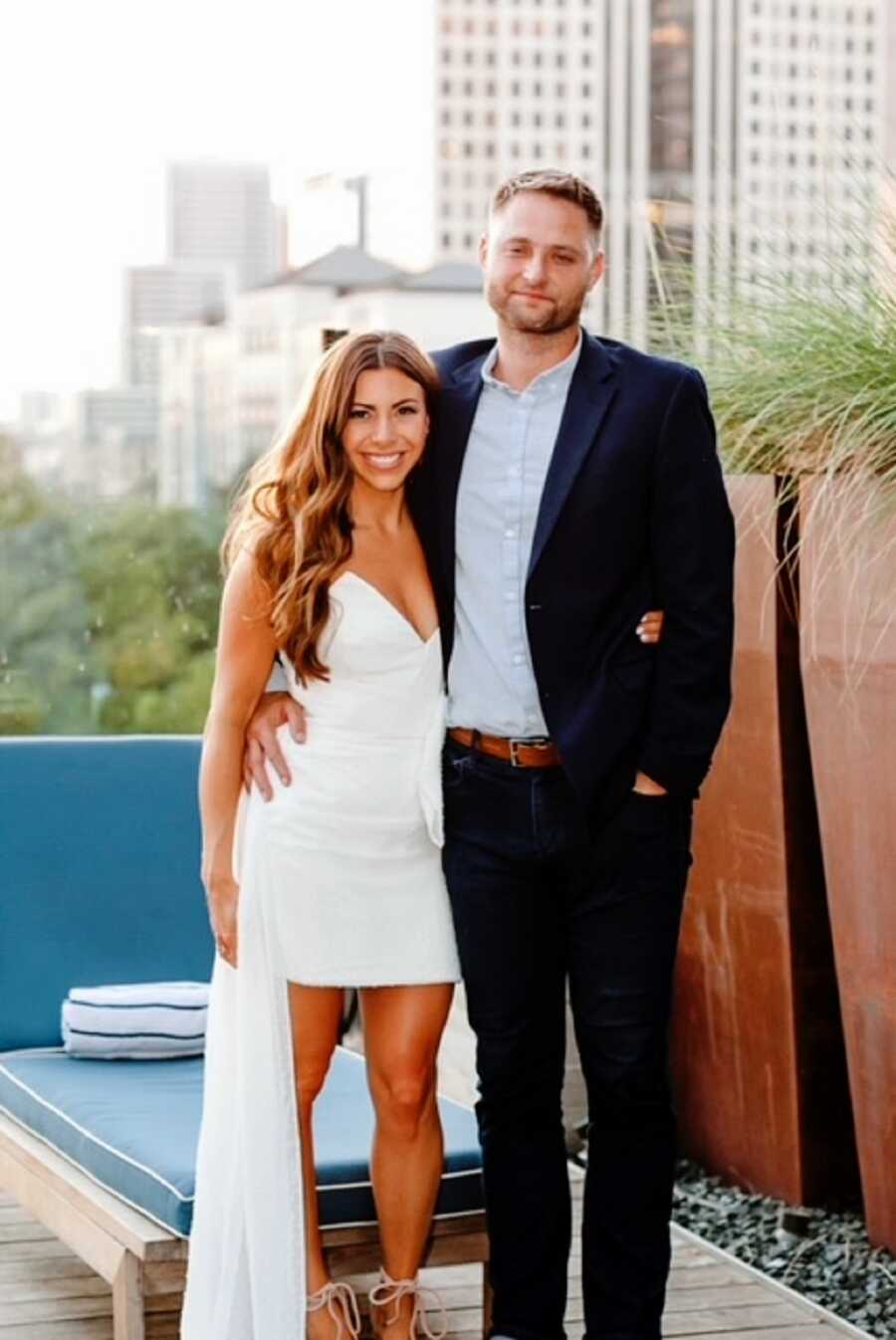 A woman and her husband stand outdoors