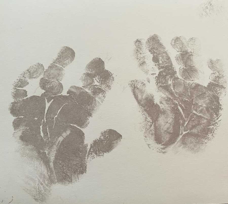 stillborn baby's handprints on paper in ink