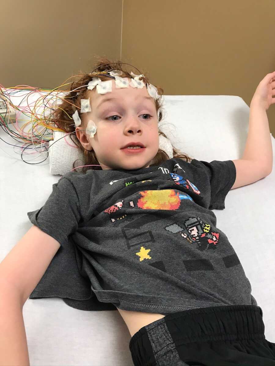 little boy in hospital bed with wires on head 