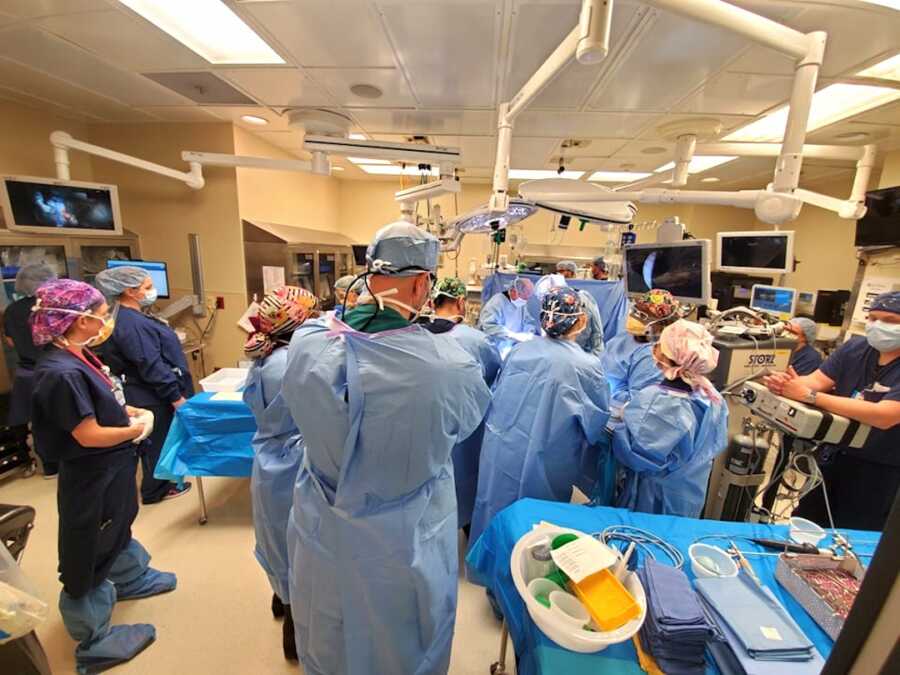 team of doctors and nurses in delivery room for labor