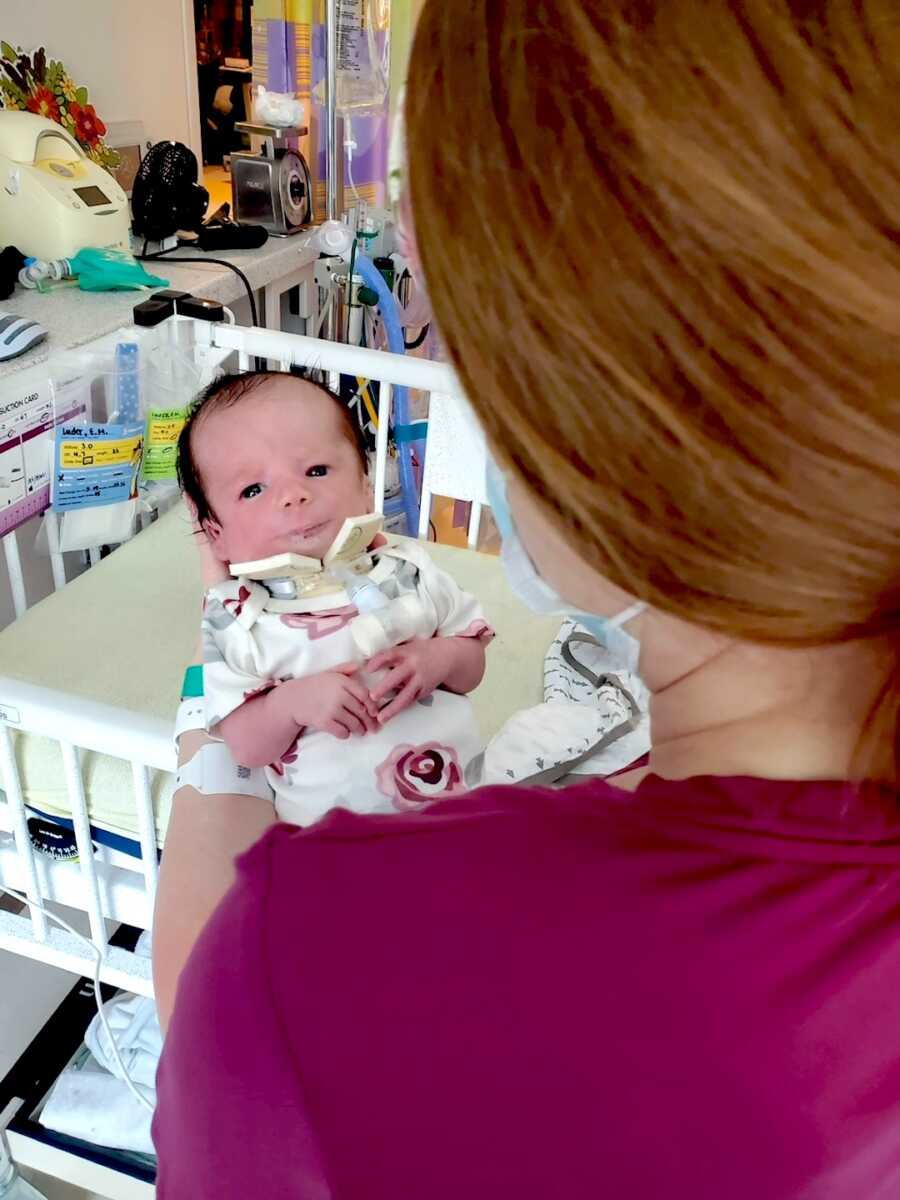mom holds newborn daughter with nager syndrome