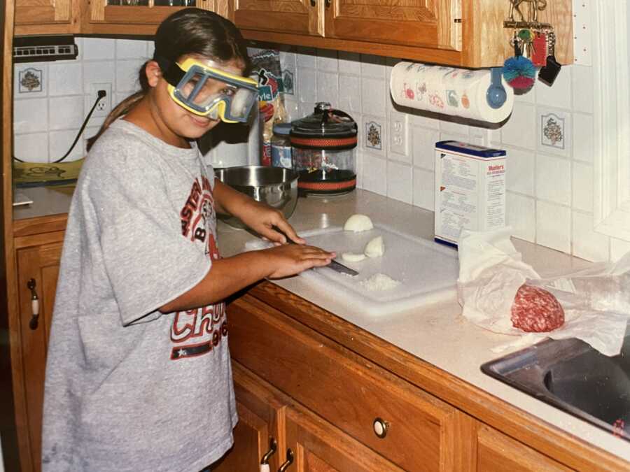 little girl cutting up onions