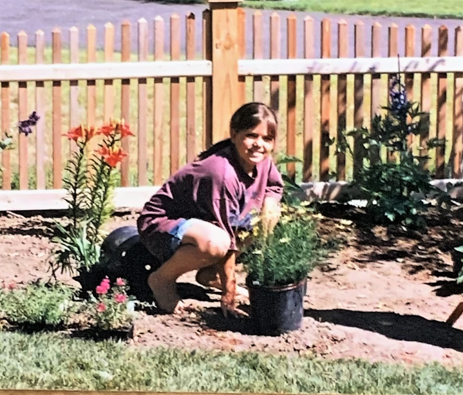 little girl planting flowers