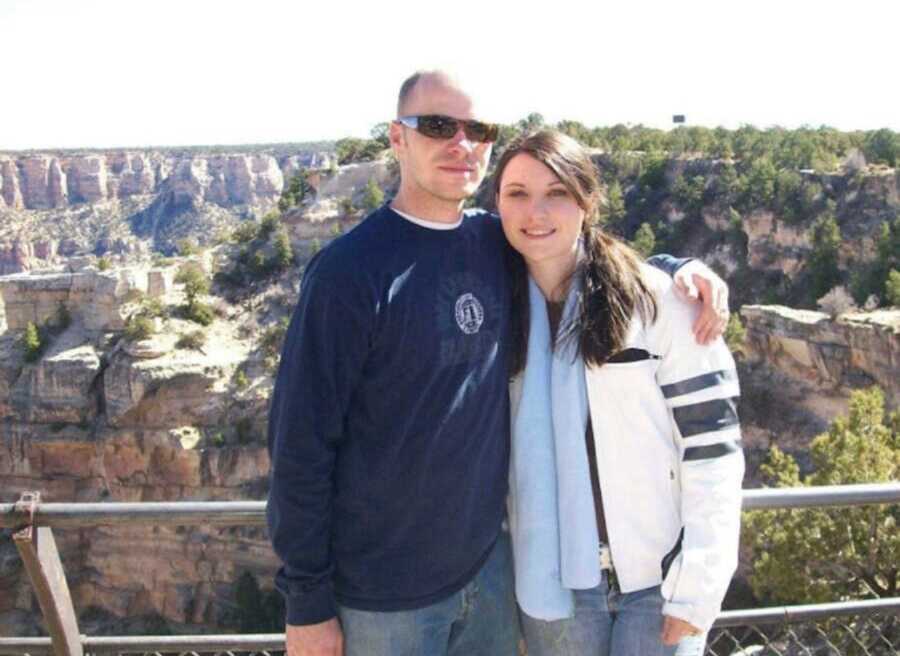 Couple hoping to adopt stand in front of canyon.