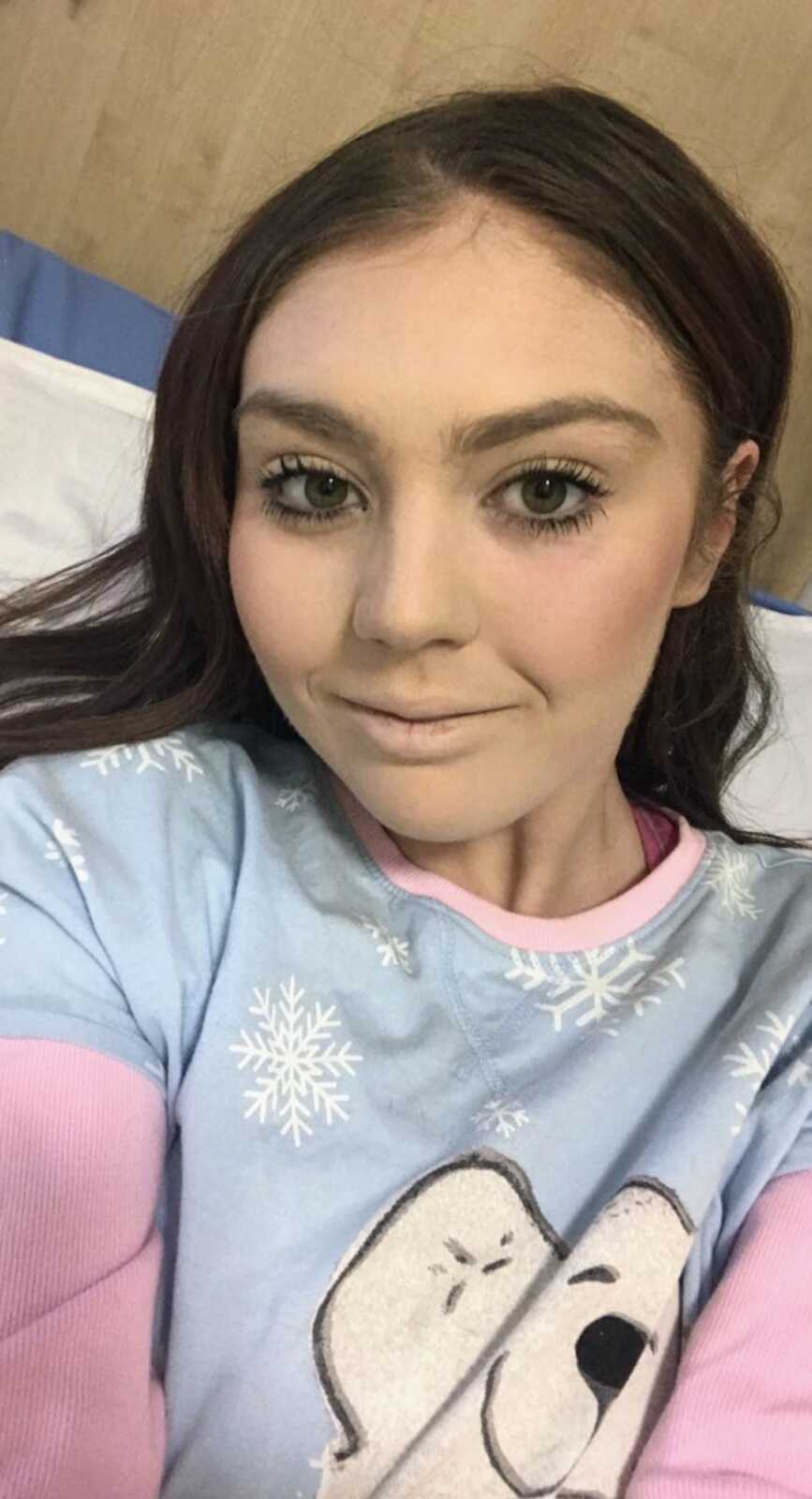 young woman takes a selfie in a hospital bed