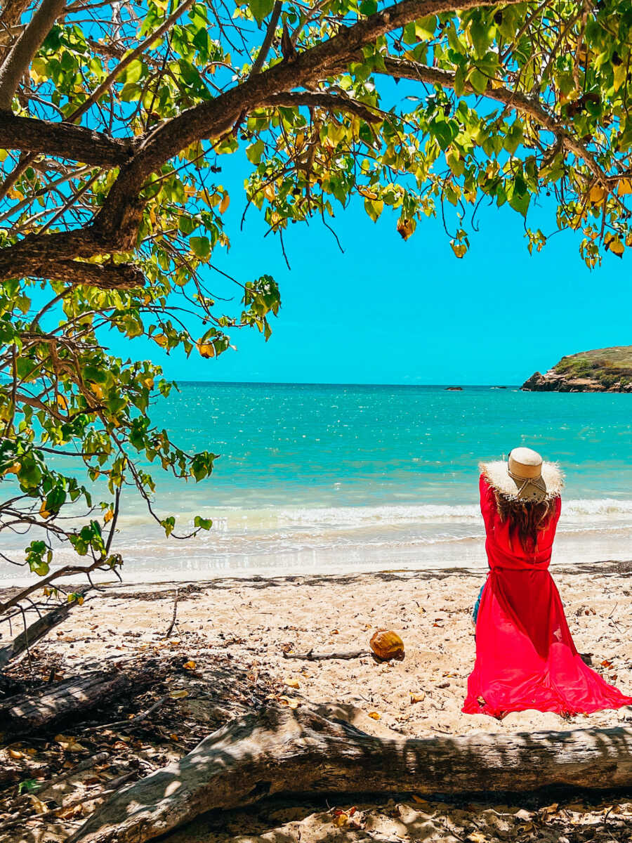 A nurse poses in front of a large beach