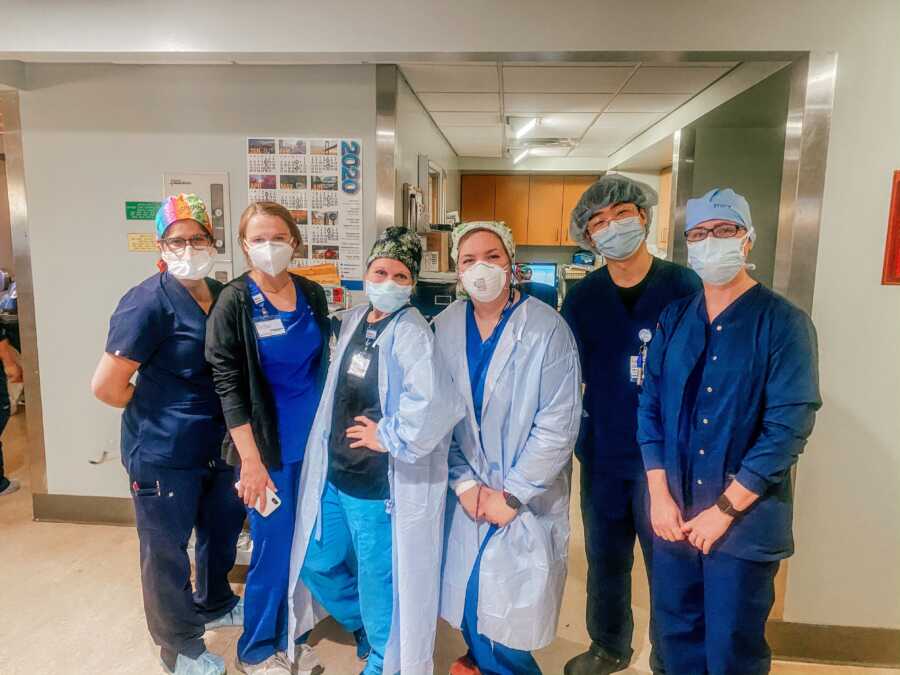 6 travel nurses pose together in a hospital