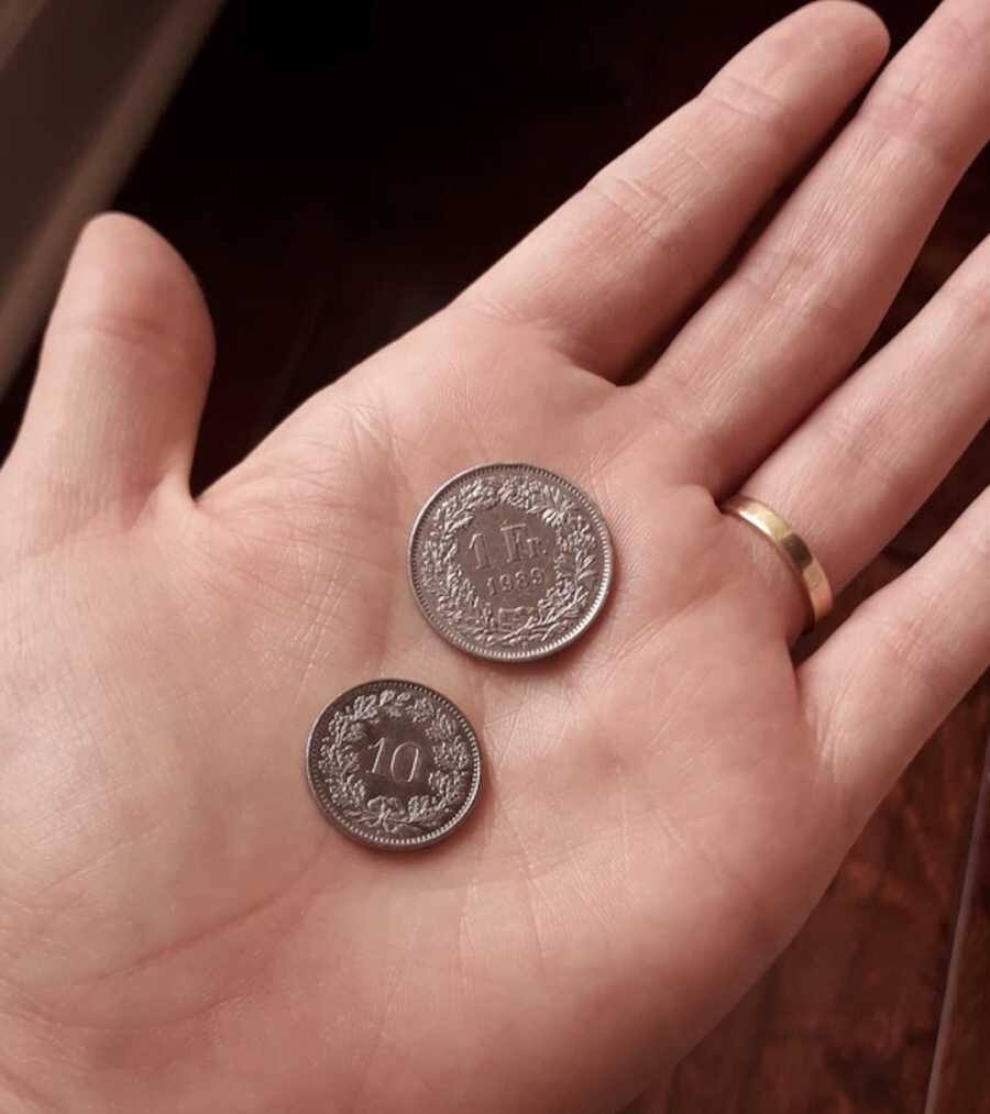 two Swiss coins widow found on floor, sign from late husband