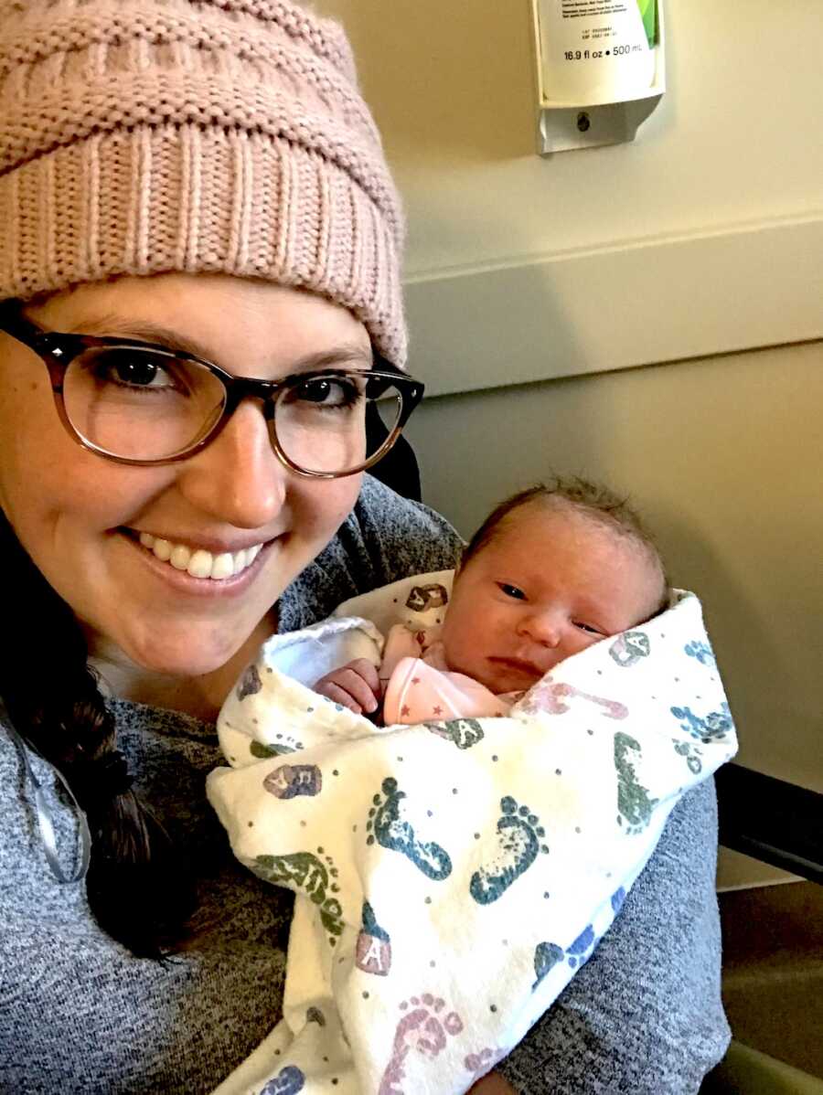 adoptive mom takes selfie with baby girl while she is wrapped up in blanket