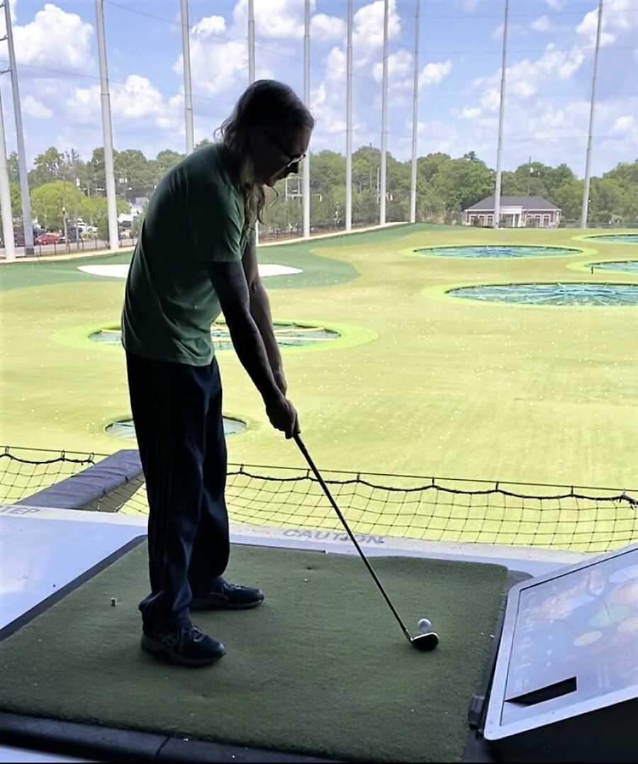 man playing at the golfing range