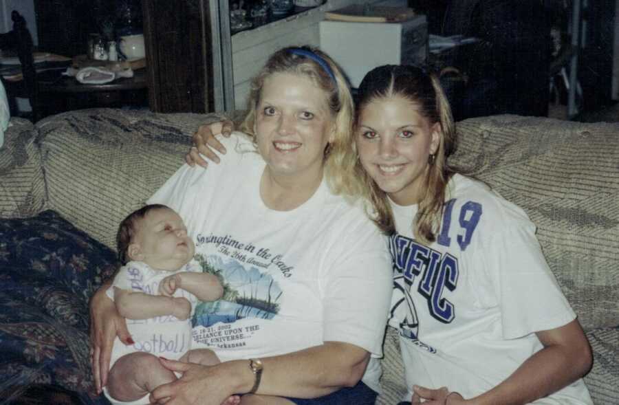 A teen mom and her mother sit with her newborn baby