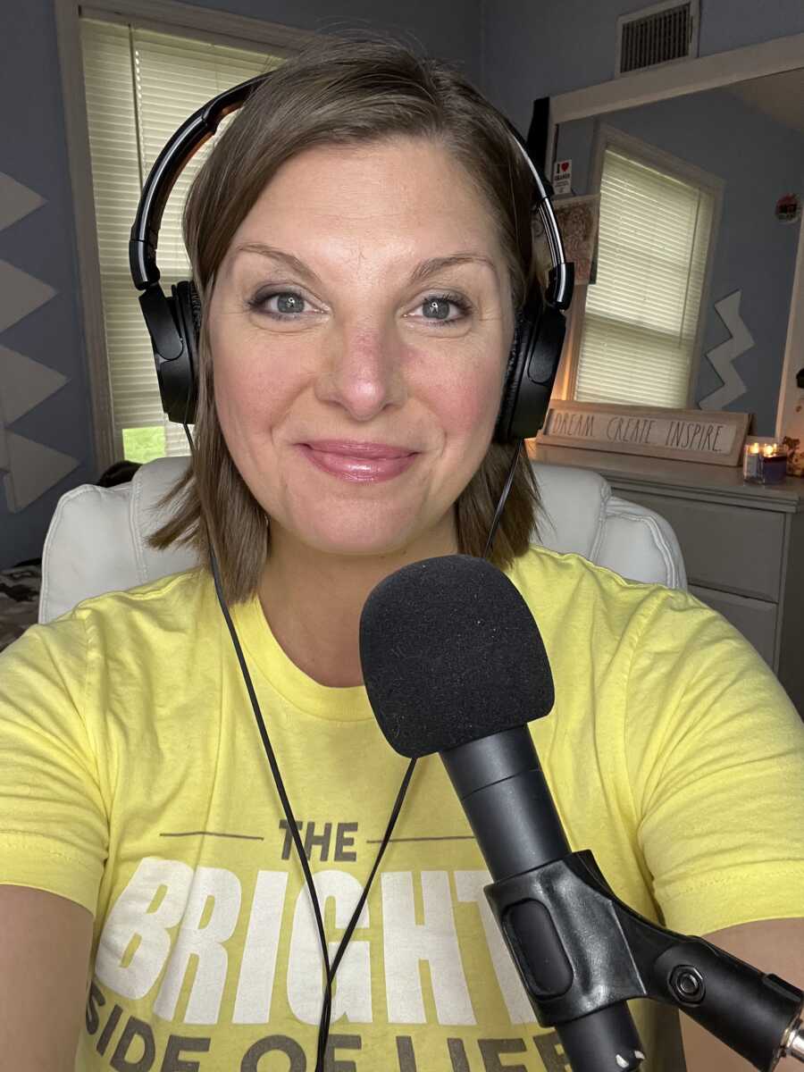 New podcast host smiles in front of her microphone about to record 