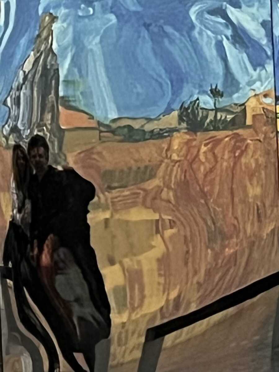 Couple takes picture at immersive Van Gogh experience in Los Angeles.