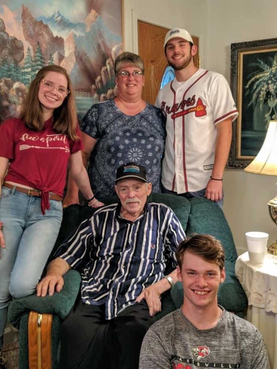 A family poses in their living room