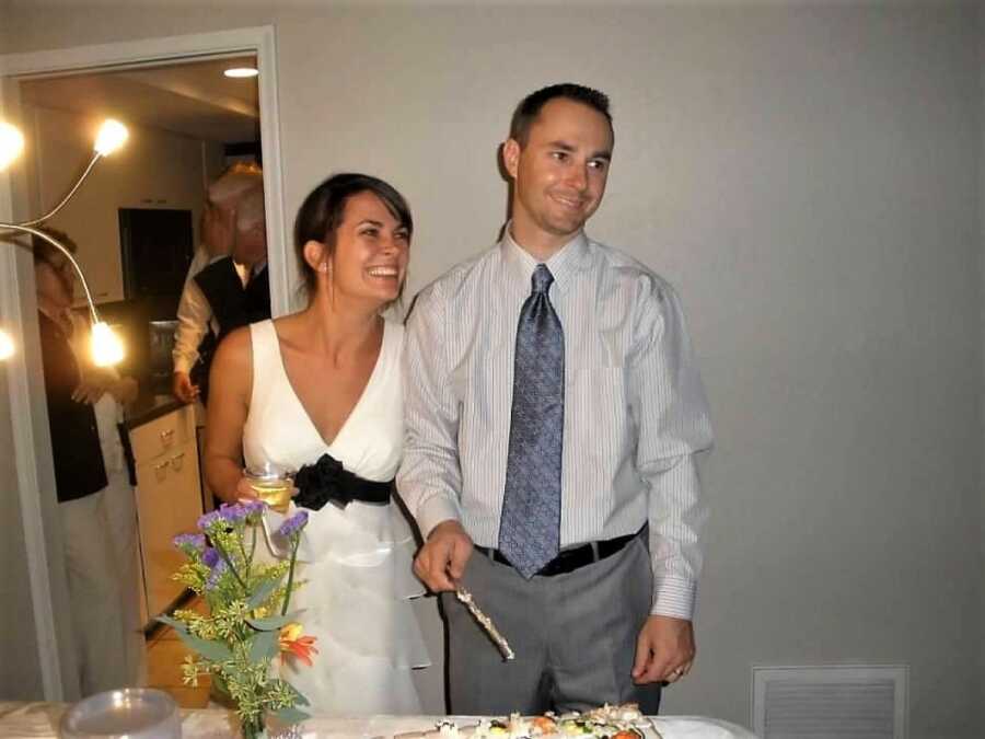 couple at their wedding holding their hands 