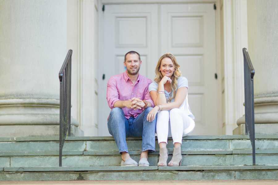 couple sitting on steps together smiling
