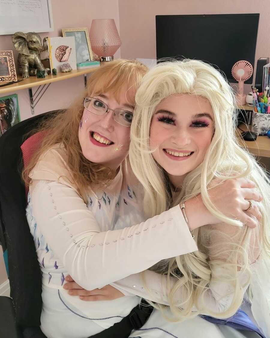 Autistic woman hugging Elsa role player 
