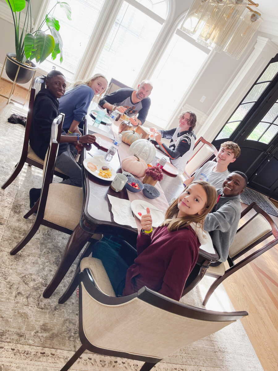 large family gathers at the dining room table