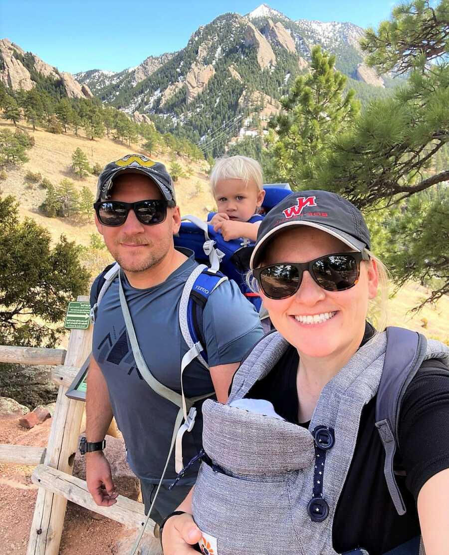 Military couple hiking mountains with their two babies 