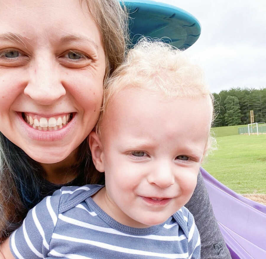 Stay-at-home-mom taking a selfie with her toddle son at the playground 