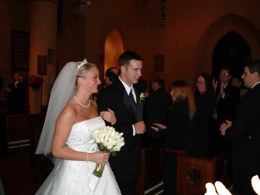 bride and groom on their wedding day walking down aisle