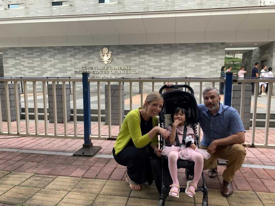 adoptive couple with internationally adopted daughter in stroller