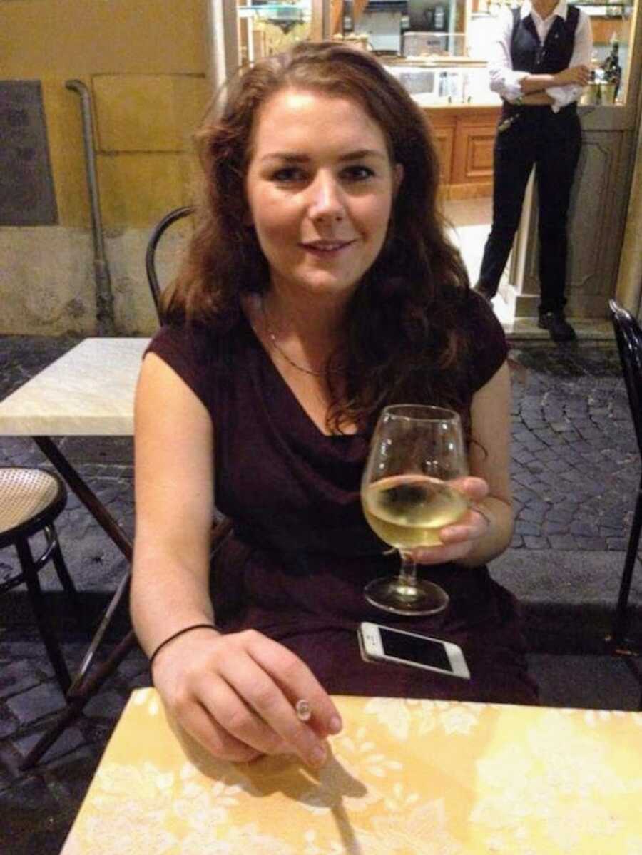 alcoholic holding a wine glass in a restaurant