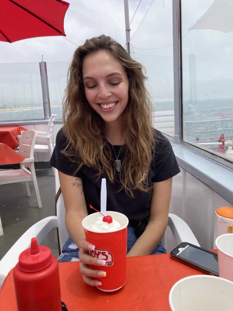 anorexia survivor with a milkshake at a restaurant 