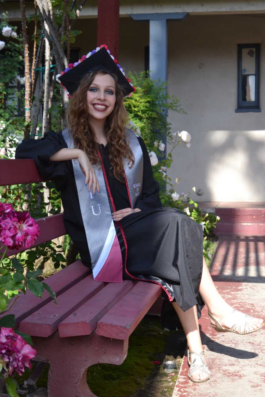 anorexic woman in college graduation gown and cap