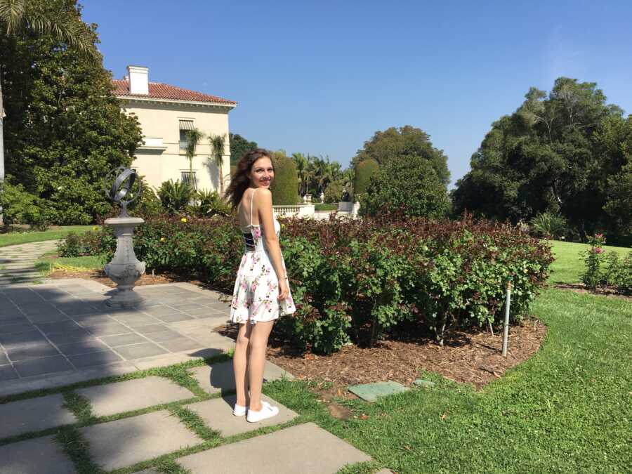 anorexic woman in garden wearing a white dress