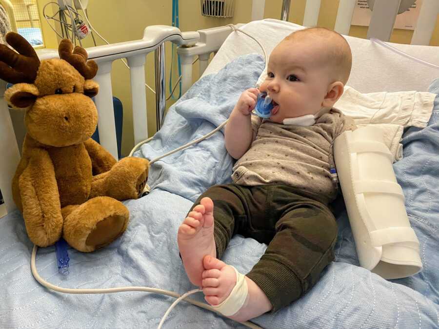 baby boy post neck procedure for cyst in hospital bed